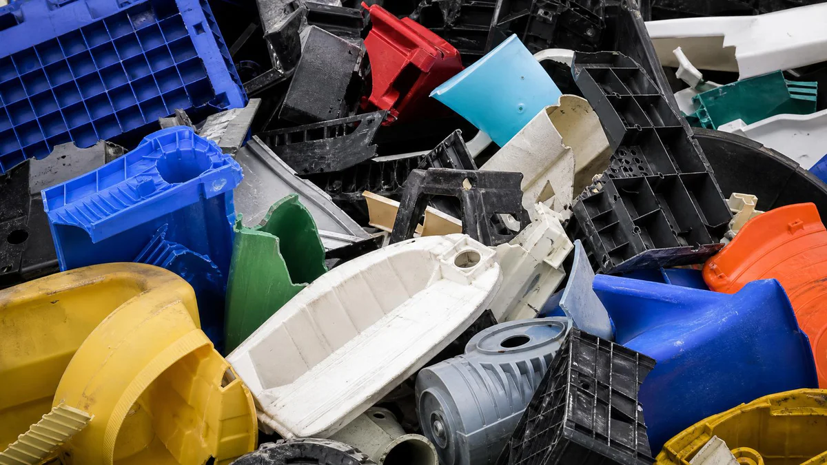 Large plastic pipe, profile, and sheet scrap waiting to be crushed