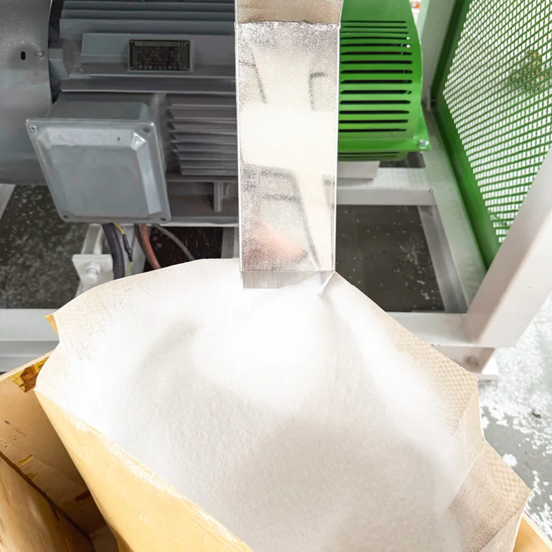 Crushed regrind and plastic powder samples compared on a tray