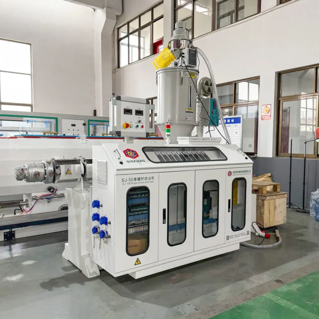 Plastic extrusion machine for pipe and profile production in factory setting