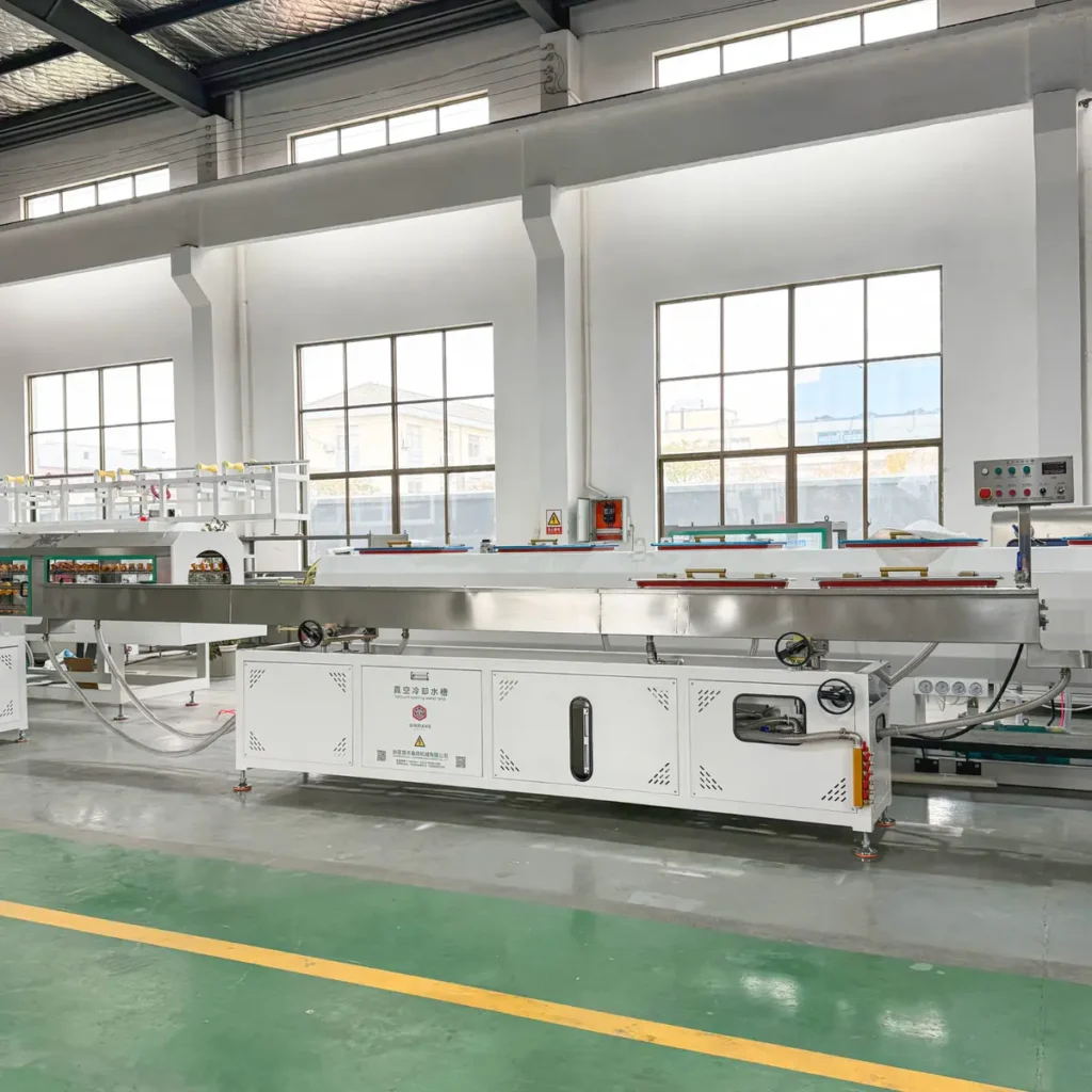Plastic extrusion machine for manufacturing plastic pipes and profiles in factory setting