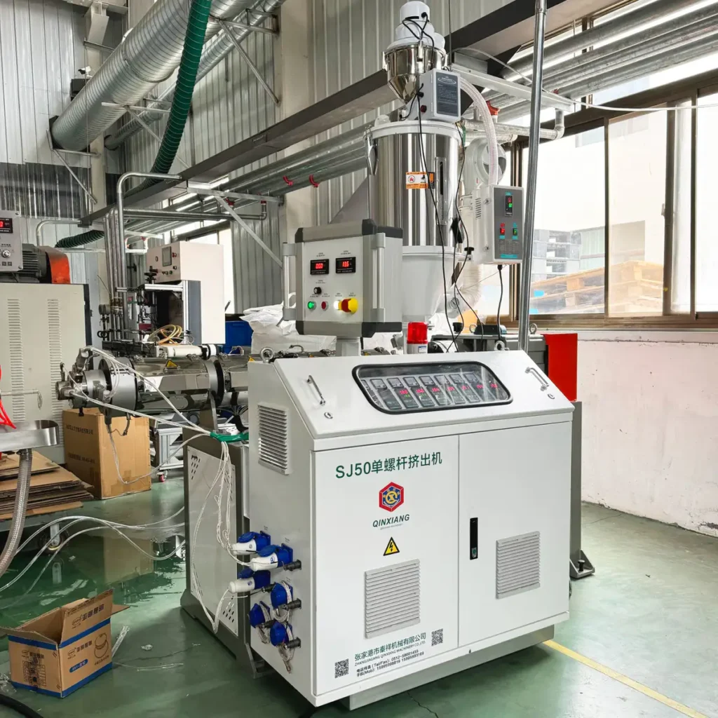 Plastic extrusion machine used for manufacturing plastic pipes and profiles in a factory setting