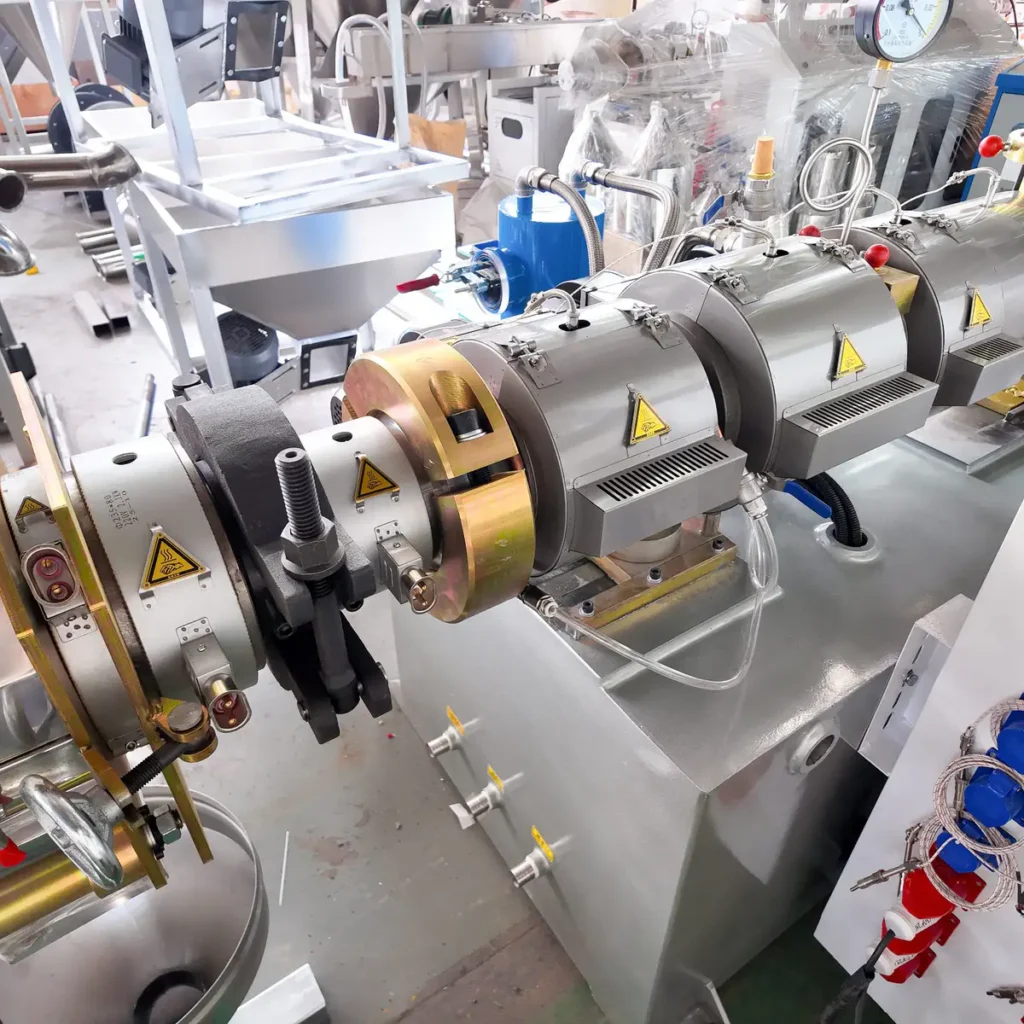Plastic extrusion machine used for manufacturing plastic pipes and profiles in a factory setting