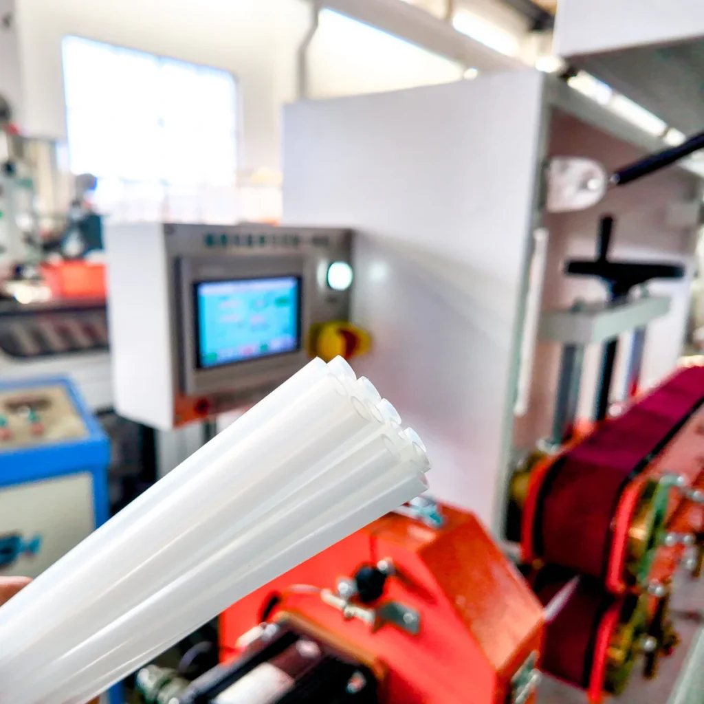 Plastic extrusion machine for manufacturing plastic pipes and profiles in a showroom scene